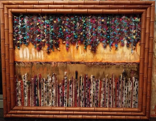 Enclosed in a thick bamboo-style frame, the piece is divided horizontally. The top section features a dense, vibrant canopy of clustered textile elements hanging over a textured, golden-orange background. The bottom section consists of dense, vertical rows of multicolored bound threads standing upright.The bottom section consists of dense, vertical rows of multicolored bound threads standing upright.